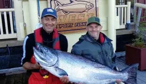 fish-11 Two men and a Chinook salmon in front of King Pacific Lodge