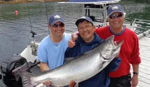fish-12 Three men and their Chinook salmon catch standing on the dock