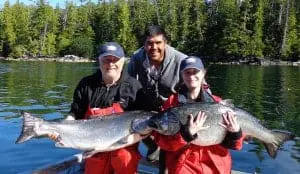 fish-19 Three men hold their two Chinook salmons near the dock