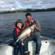 child hand holding fish and smiling