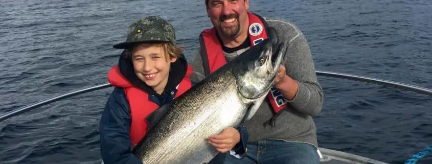 child hand holding fish and smiling