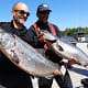 Two men show off their King salmon catch