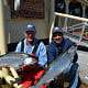 Two men showing off their Chinook salmon catch