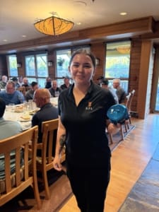 Torianne showcasing the Islander fishing rod and reel auctioned off to support the Heiltsuk Mens Wellness group